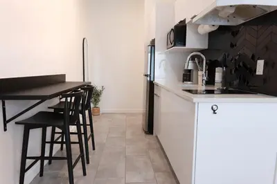 a kitchen with a counter and stools in it at #3 - Chic Studio - Self Check in - Plateau - St-Denis - AC - TV in Montréal