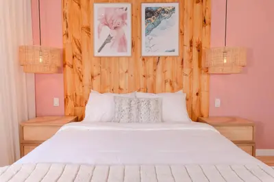 a bedroom with a white bed and two pictures on the wall at #4 - Quaint Studio - Self Check in - Plateau - St-Denis - AC - TV in Montréal