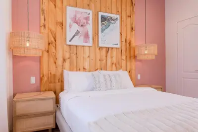 a bedroom with a white bed and two pictures on the wall at #4 - Quaint Studio - Self Check in - Plateau - St-Denis - AC - TV in Montréal