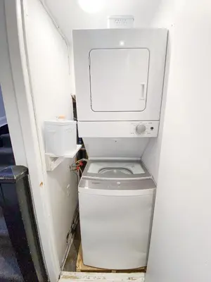 a white washer and dryer in a small room at #4 - Quaint Studio - Self Check in - Plateau - St-Denis - AC - TV in Montréal
