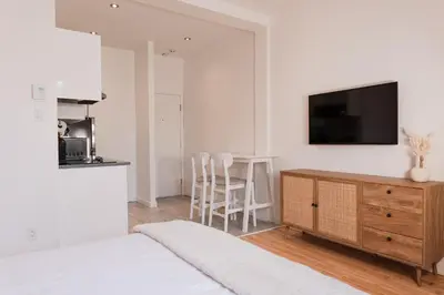 a bedroom with a bed and a tv on a wall at #4 - Quaint Studio - Self Check in - Plateau - St-Denis - AC - TV in Montréal