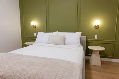 a bedroom with a white bed and a table at #5 - Spacious 3Bds - Self Check in - Plateau - St-Denis - AC - TV in Montréal