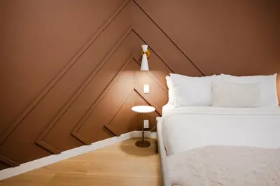 a bedroom with a white bed and a brown wall at #5 - Spacious 3Bds - Self Check in - Plateau - St-Denis - AC - TV in Montréal