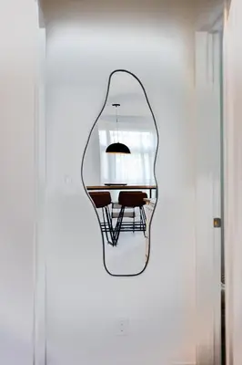 a mirror hanging on a wall in a room at #5 - Spacious 3Bds - Self Check in - Plateau - St-Denis - AC - TV in Montréal