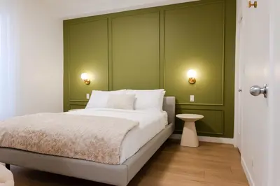 a bedroom with a white bed and green walls at #5 - Spacious 3Bds - Self Check in - Plateau - St-Denis - AC - TV in Montréal