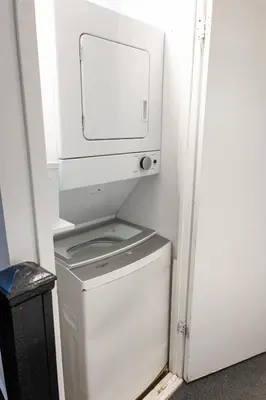 a washer and dryer with a computer on top of it at #6 - Artistic Studio - Self Check in - Plateau - St-Denis - AC - TV in Montréal