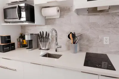 a kitchen counter with a sink and a microwave at #7 - Charming Studio - Self Check in - Plateau - St-Denis - AC - TV in Montréal