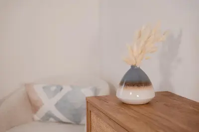 a vase sitting on top of a wooden table at #7 - Charming Studio - Self Check in - Plateau - St-Denis - AC - TV in Montréal