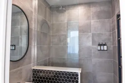 a bathroom with a shower with a large mirror at #7 - Charming Studio - Self Check in - Plateau - St-Denis - AC - TV in Montréal