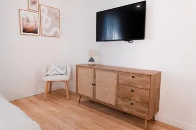 a bedroom with a dresser and a tv on a wall at #7 - Charming Studio - Self Check in - Plateau - St-Denis - AC - TV in Montréal