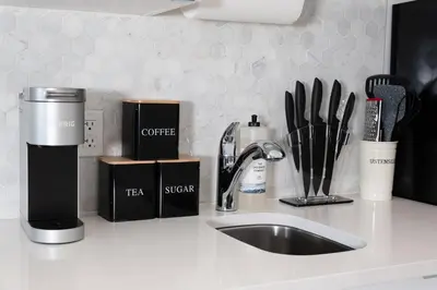 a kitchen counter with a sink and utensils at #8 - Refined Studio - Self Check in - Plateau - St-Denis - AC - TV in Montréal