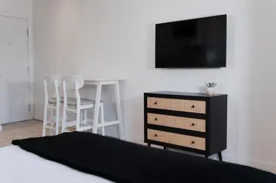 a bedroom with a bed and a desk and a tv at #8 - Refined Studio - Self Check in - Plateau - St-Denis - AC - TV in Montréal