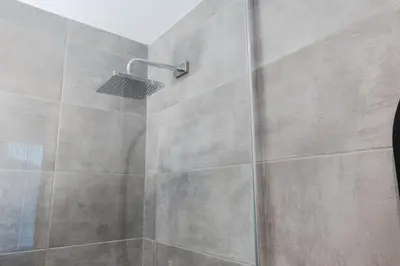 a bathroom with a shower with a glass door at #8 - Refined Studio - Self Check in - Plateau - St-Denis - AC - TV in Montréal