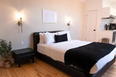 a bedroom with a large bed with white sheets and pillows at #9 - Classic Studio - Self Check in - Plateau - St-Denis - AC - TV in Montréal