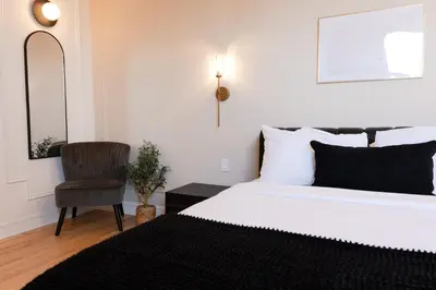 a bedroom with a white bed and a chair at #9 - Classic Studio - Self Check in - Plateau - St-Denis - AC - TV in Montréal