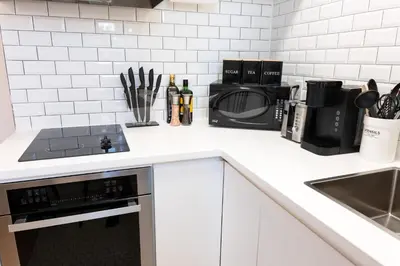 a kitchen counter with a microwave and a stove at #9 - Classic Studio - Self Check in - Plateau - St-Denis - AC - TV in Montréal