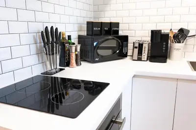 a kitchen counter with a microwave and a stove at #9 - Classic Studio - Self Check in - Plateau - St-Denis - AC - TV in Montréal