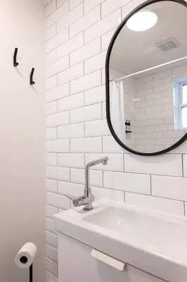 a white bathroom with a sink and a mirror at #9 - Classic Studio - Self Check in - Plateau - St-Denis - AC - TV in Montréal