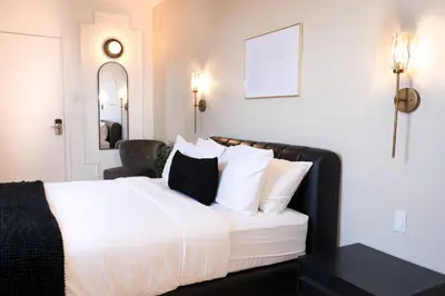 a bedroom with a white bed with black and white pillows at #9 - Classic Studio - Self Check in - Plateau - St-Denis - AC - TV in Montréal
