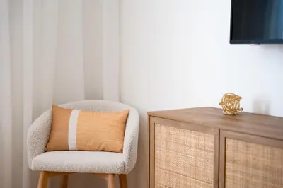 a chair with a pillow on it next to a desk at #10 - Serene Studio - Self Check in - Plateau - St-Denis - AC - TV in Montréal