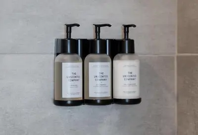 a group of three shampoo bottles sitting on a counter at #10 - Serene Studio - Self Check in - Plateau - St-Denis - AC - TV in Montréal