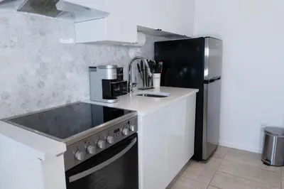 a kitchen with a sink and a refrigerator at #11 - Upscale Studio - Self Check in - Plateau - St-Denis - AC - TV in Montréal