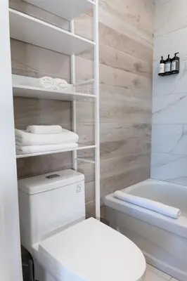 a bathroom with a white toilet and a bath tub at #11 - Upscale Studio - Self Check in - Plateau - St-Denis - AC - TV in Montréal