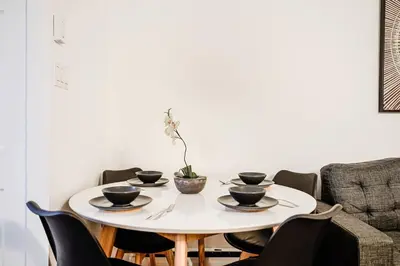 a white table with four black bowls on it at Charmant appartement de 2 chambres à Griffintown in Montréal