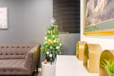 a christmas tree in a living room with a couch at Cozy 2-Bedroom in Griffintown in Montréal
