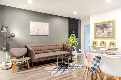 a living room with a couch and a table at Cozy 2-Bedroom in Griffintown in Montréal