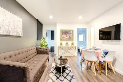 a living room with a couch and a table at Cozy 2-Bedroom in Griffintown in Montréal