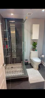 a bathroom with a shower and a toilet at Condo 2 chambres avec parking privé - Griffintown in Montréal