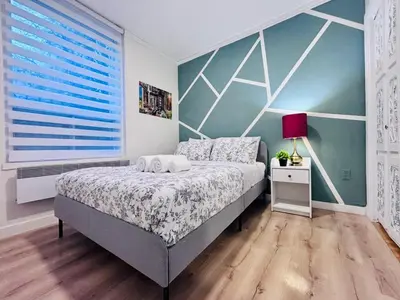 a bedroom with a bed and a large window at Small but Equipped Unit in Montréal
