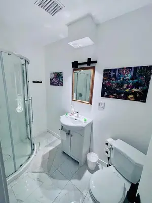 a bathroom with a toilet and a sink and a shower at Small but Equipped Unit in Montréal