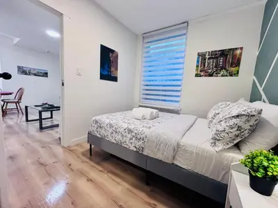 a bedroom with a bed and a large window at Small but Equipped Unit in Montréal