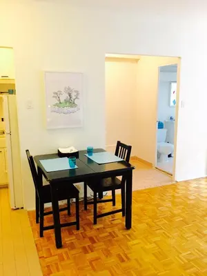 a dining room with a table and two chairs at Stylish Montreal Apartment Comfortable Stay in the Golden Square Mile in Montréal