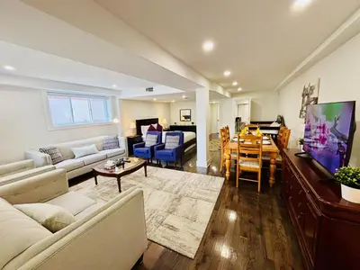 a living room with a couch and a dining room at Opulent Studio - Semi Basement in Montréal