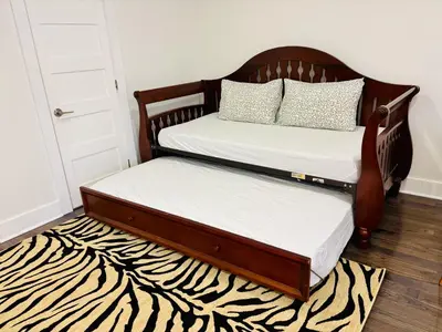 two twin beds in a room with a zebra rug at Opulent Studio - Semi Basement in Montréal