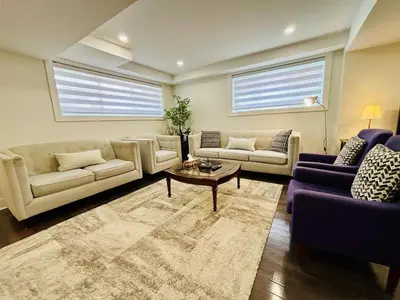 a living room with couches and a coffee table at Opulent Studio - Semi Basement in Montréal