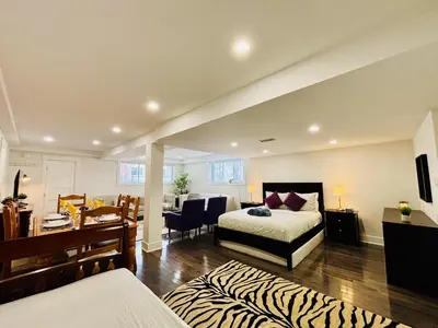 a bedroom with a bed and a desk and a room at Opulent Studio - Semi Basement in Montréal