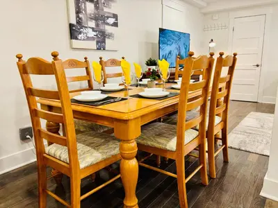 a dining room with a wooden table and chairs at Opulent Studio - Semi Basement in Montréal