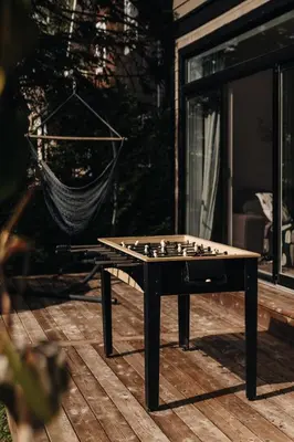 a chess board sitting on a wooden deck at Chalet Chti - bord de l'eau mont Orford in Eastman