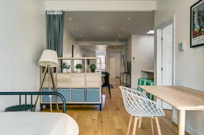 a room with a bed and a table and chairs at Spacious Group Haven Near Trendy St Laurent in Montréal