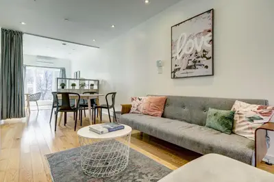 a living room with a couch and a table at Spacious Group Haven Near Trendy St Laurent in Montréal