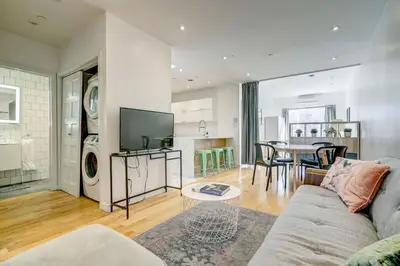 a living room with a couch and a table at Spacious Group Haven Near Trendy St Laurent in Montréal