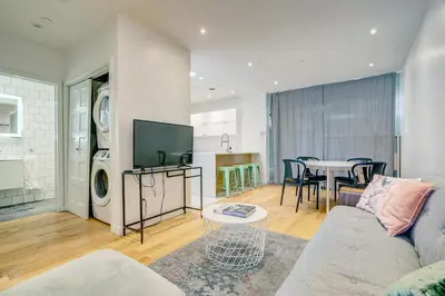 a living room with a couch and a table at Spacious Group Haven Near Trendy St Laurent in Montréal