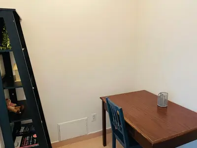 a dining room table with a chair and a book shelf at Stylish Montreal Apartment Comfortable Stay in the Golden Square Mile in Montréal