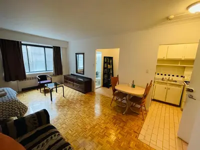 a living room with a couch and a table at Stylish Montreal Apartment Comfortable Stay in the Golden Square Mile in Montréal