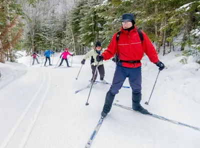 a group of people cross country skiing in the snow at Le POD du Mont ADSTOCK spa ski motoneige VTT plein air arcade in Adstock