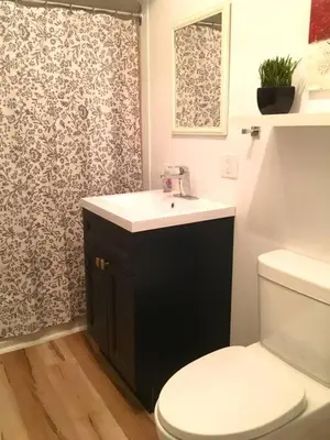 a bathroom with a toilet and a sink at Fully furnished 2 bedroom unit, downtown, near subway, 32 days minimum in Montréal